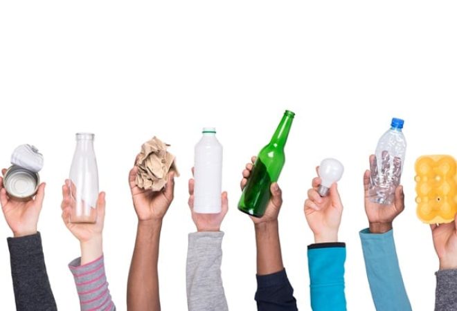 Garbage that can be recycled held in hands isolated on white background
