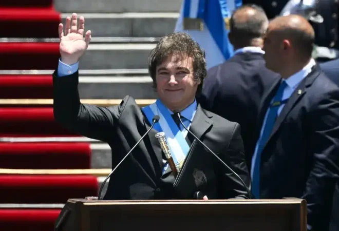 105261730-topshot-argentinas-new-president-javier-milei-waves-at-supporters-as-he-delivers-his-in