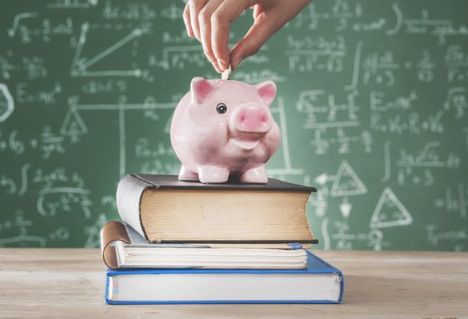 Female putting coin into piggy bank