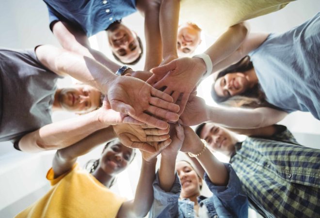 Close-up of business executives with hand stacked in office