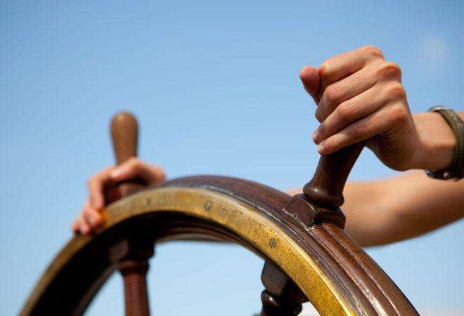 Hand on ship rudder.