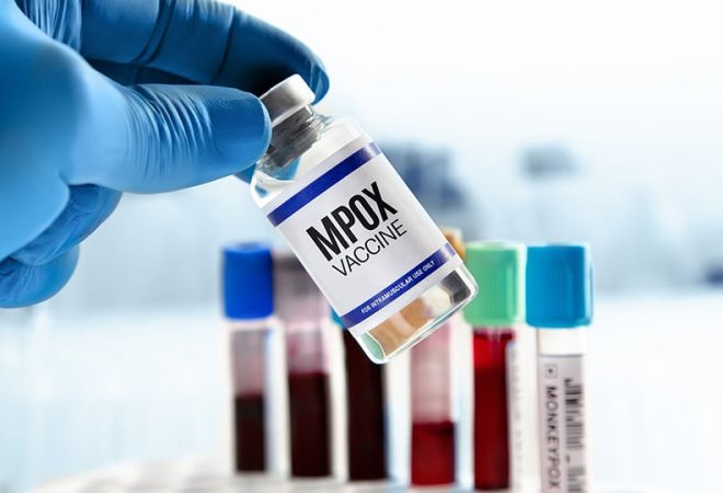 Bottle of Vaccine for booster shot for Smallpox and Monkeypox MPXV. Doctor with vial of the doses vaccine for MPOX monkeypox disease