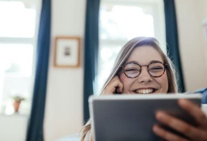 Woman-smiling-using-tablet-at-home_470x280