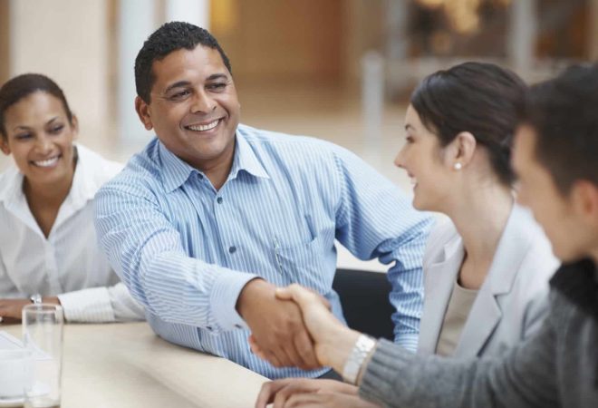 Mature man handshaking with partner after striking a business deal