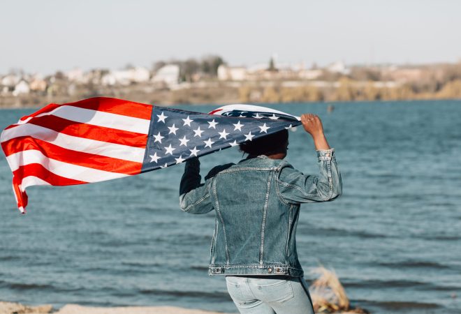 black-woman-turned-back-holding-american-flag
