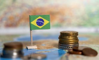 brazilian flag with stacks of coins on a map, symbolizing the economy, currency, financial growth, international trade, and investment potential of brazil