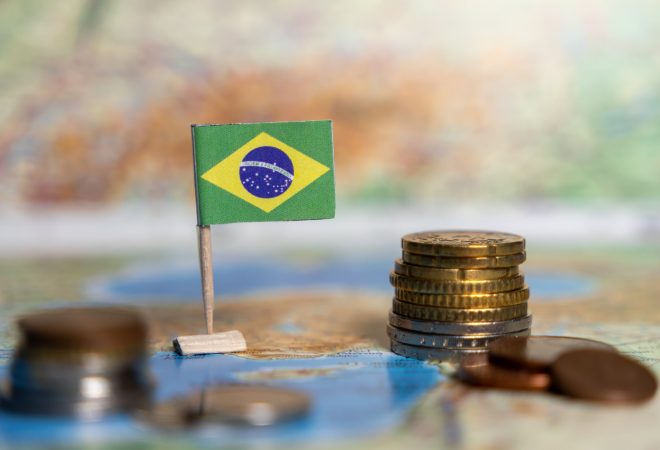 brazilian flag with stacks of coins on a map, symbolizing the economy, currency, financial growth, international trade, and investment potential of brazil