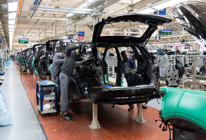 Car bodies are on assembly line. Factory for production of cars. Modern automotive industry. A car being checked before being painted in a high-tech enterprise.