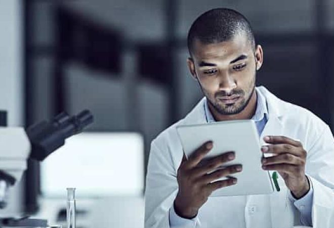 Shot of a scientist recording his findings on a digital tablet