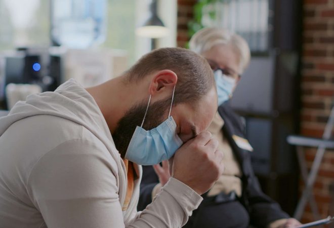 Close up of man crying because of mental health issues at aa therapy meeting. Desperate adult asking for help and advice to cure addiction and depression at support group session.