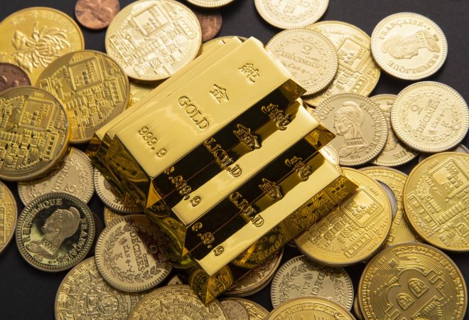 A closeup shot of a pile of shiny gold coins and bars