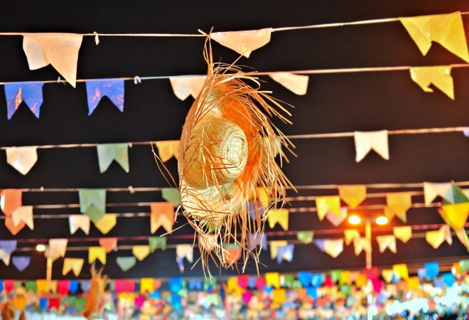 Traditional straw hat for decoration. Brazilian festival of São João and Festa Junina. Object used in June festivals in Brazil. Known as "straw hat". Straw hat and flags for June festival.