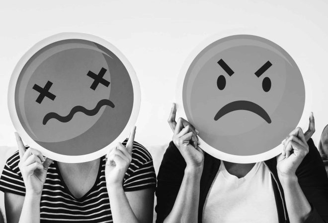 Diverse people holding emoticon