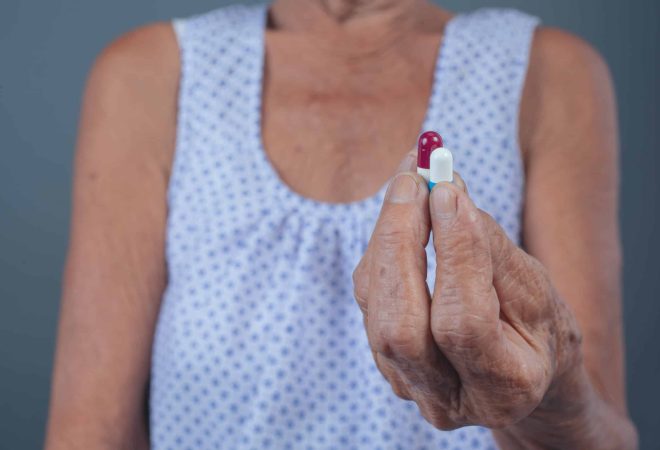 Elderly women taking medicine.