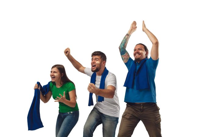 Excellent goal. Three soccer fans woman and men cheering for favourite sport team with bright emotions isolated on white studio background. Looking excited, supporting. Concept of sport, fun, support.
