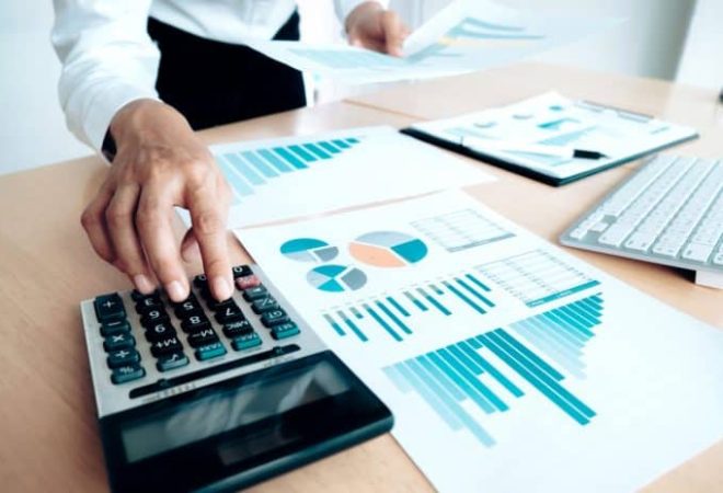 finances-saving-economy-concept-female-accountant-or-banker-use-calculator-696x464