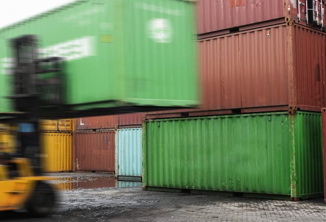 Forklift unloading a container box