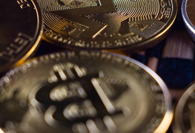 A vertical closeup shot of many cryptocurrency coins