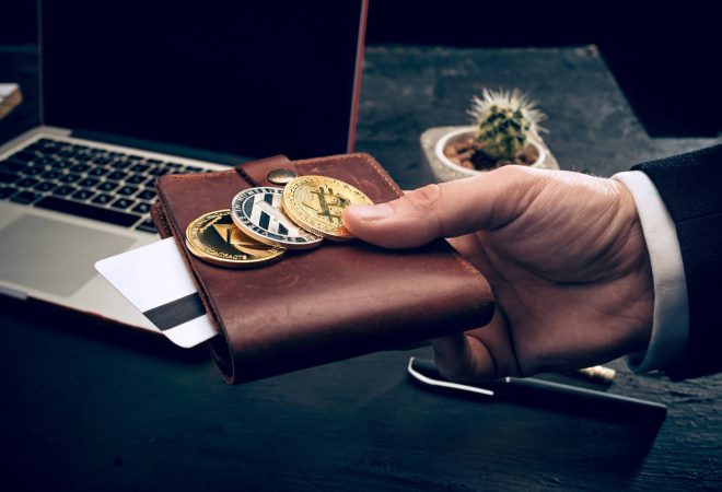 The golden bitcoin and purse in male hands. Cryptocurrency bitcoin coins. Litecoin, Bitcoin, Ethereum, e-commerce, busibess, finance concept. crypto currency symbol. virtual electronic money concepts