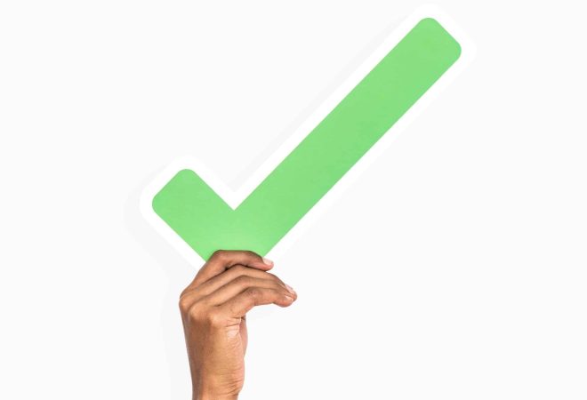Hands holding a tick mark icon