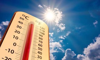 climate change, low angle view Thermometer on blue sky with sun shining in summer show increase temperature, concept global warming