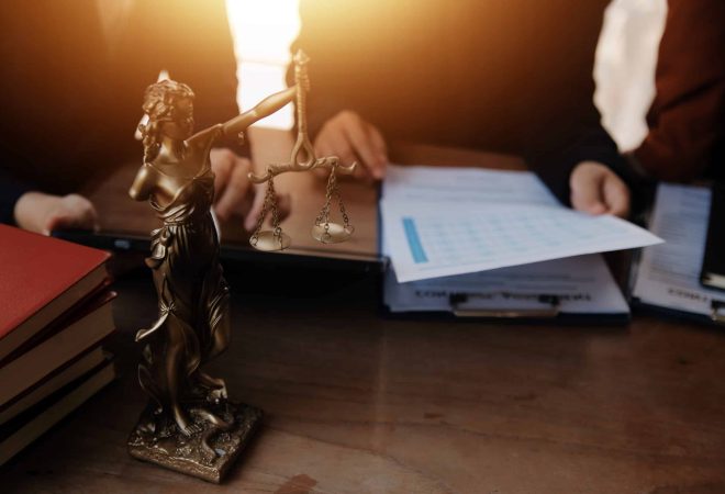 Lawyer, legal advisor, businessman brainstorming information on agreement details Business contracts in legal processing books for accuracy in contract documents. joint financial investment.