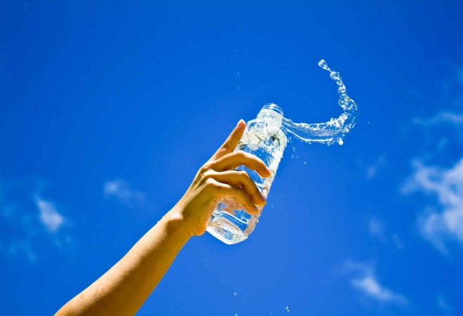 Human hand holding a bottle of water