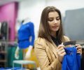 Beautiful woman checking tag in a boutique