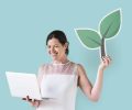Woman holding a plant icon and using a laptop