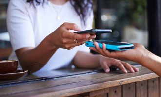 Woman, hands and phone for ecommerce, scan or transaction on wireless card machine at coffee shop. Hand of customer scanning to pay, buy or banking app with smartphone and 5G connection at cafe.