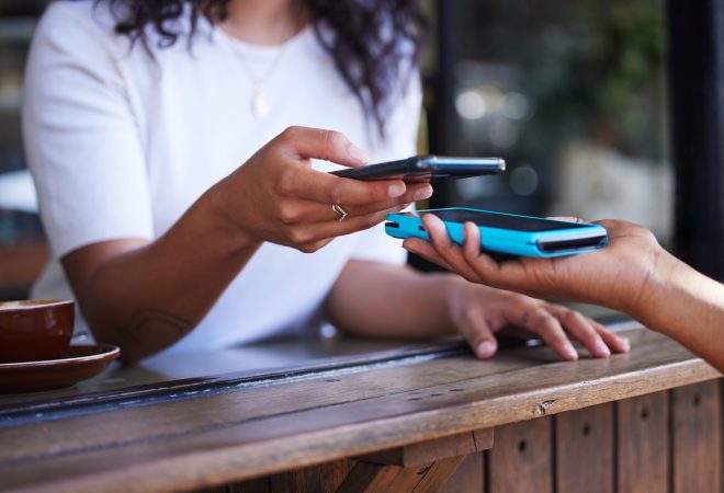 Woman, hands and phone for ecommerce, scan or transaction on wireless card machine at coffee shop. Hand of customer scanning to pay, buy or banking app with smartphone and 5G connection at cafe.