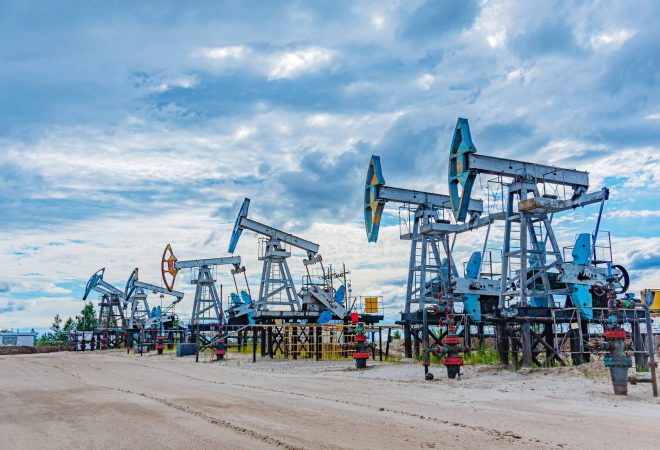 Oil pump rig. Oil and gas production. Oilfield site. Pump Jack are running. Drilling derricks for fossil fuels output and crude oil production. Global crisis. War on oil prices. Petroleum concept.