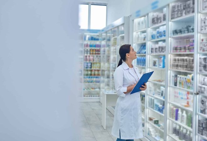Drugstore. Pharmacist checking medicines in a drugstore