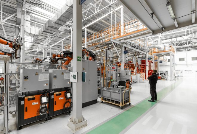 Photo of automobile production line. Welding car body. Modern car assembly plant. Auto industry. Interior of a high-tech factory, modern production.