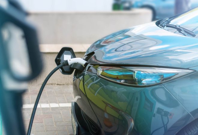 Plugged in charger into an electric car at charge station