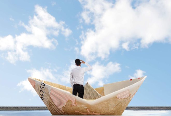 man into a bill boat on a puddle