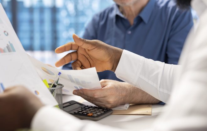 Senior people consulting with their financial banker about retirement plans, focusing on securing their financial future. Receiving professional advice for income and pension.