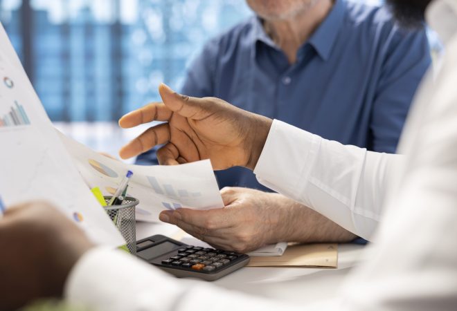 Senior people consulting with their financial banker about retirement plans, focusing on securing their financial future. Receiving professional advice for income and pension.