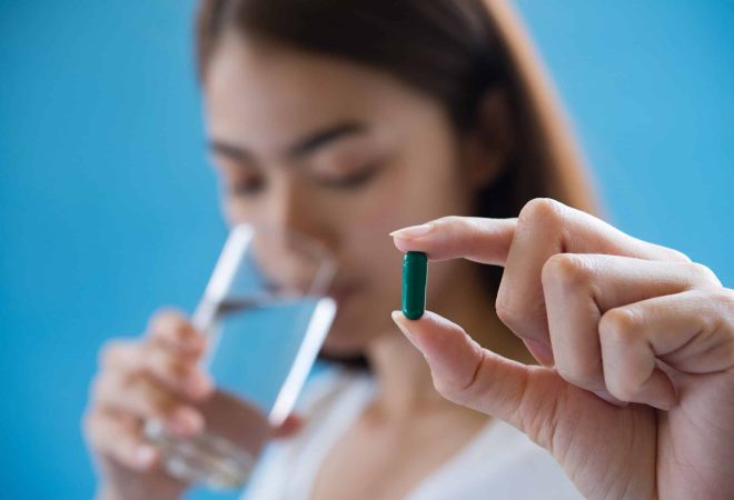 woman hand holding a pills take medicine according to the doctor's order