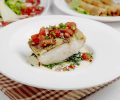 side view of baked seabass with tomatoes