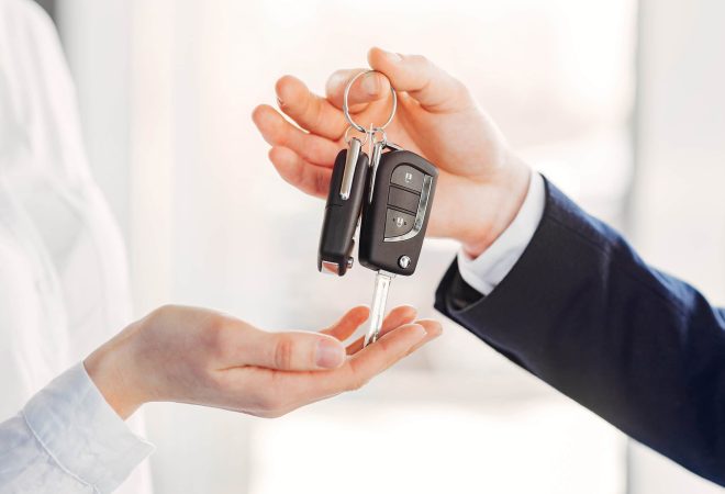 Woman buying the car. Lady in a car salon. Manager with a client