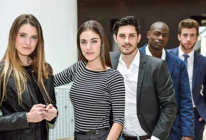 Multi-ethnic and confident business team standing in an office building