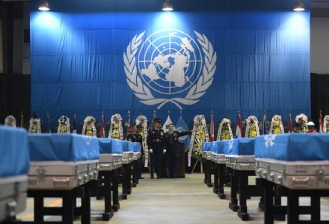 Guardas de honra da ONU ao lado de caixas com restos mortais de soldados entregues pela Coreia do Norte aos Estados Unidos