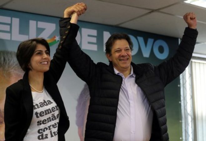Fernando Haddad, former Sao Paulo mayor and member of Workers' Party (PT), and Manuela D'avila of the Communist Party of Brazil (PCdoB) pose before a media conference in Sao Paulo