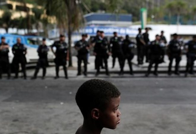 Menino participa de protesto contra violência na favela da Rocinha no Rio de Janeiro