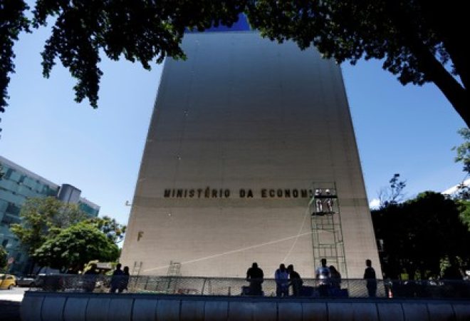 Funcionários instalam placa de identificação do Ministério da Economia no antigo prédio do Ministério do Trabalho e Emprego