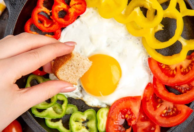 top-view-tasty-omelette-with-tomatoes-sliced-bell-peppers-dark-table