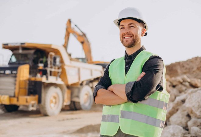 Male worker with bulldozer in sand quarry