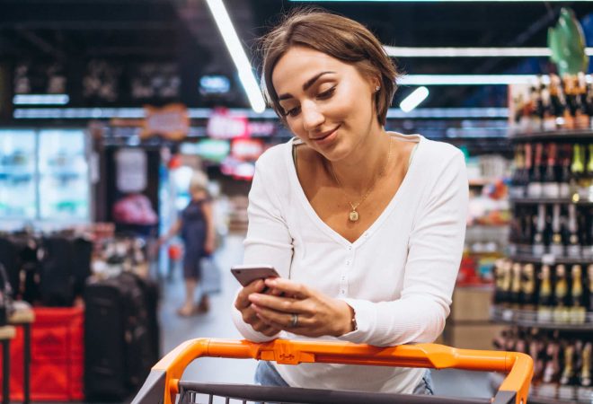 Woman shopping at the grocery store and talking on phone